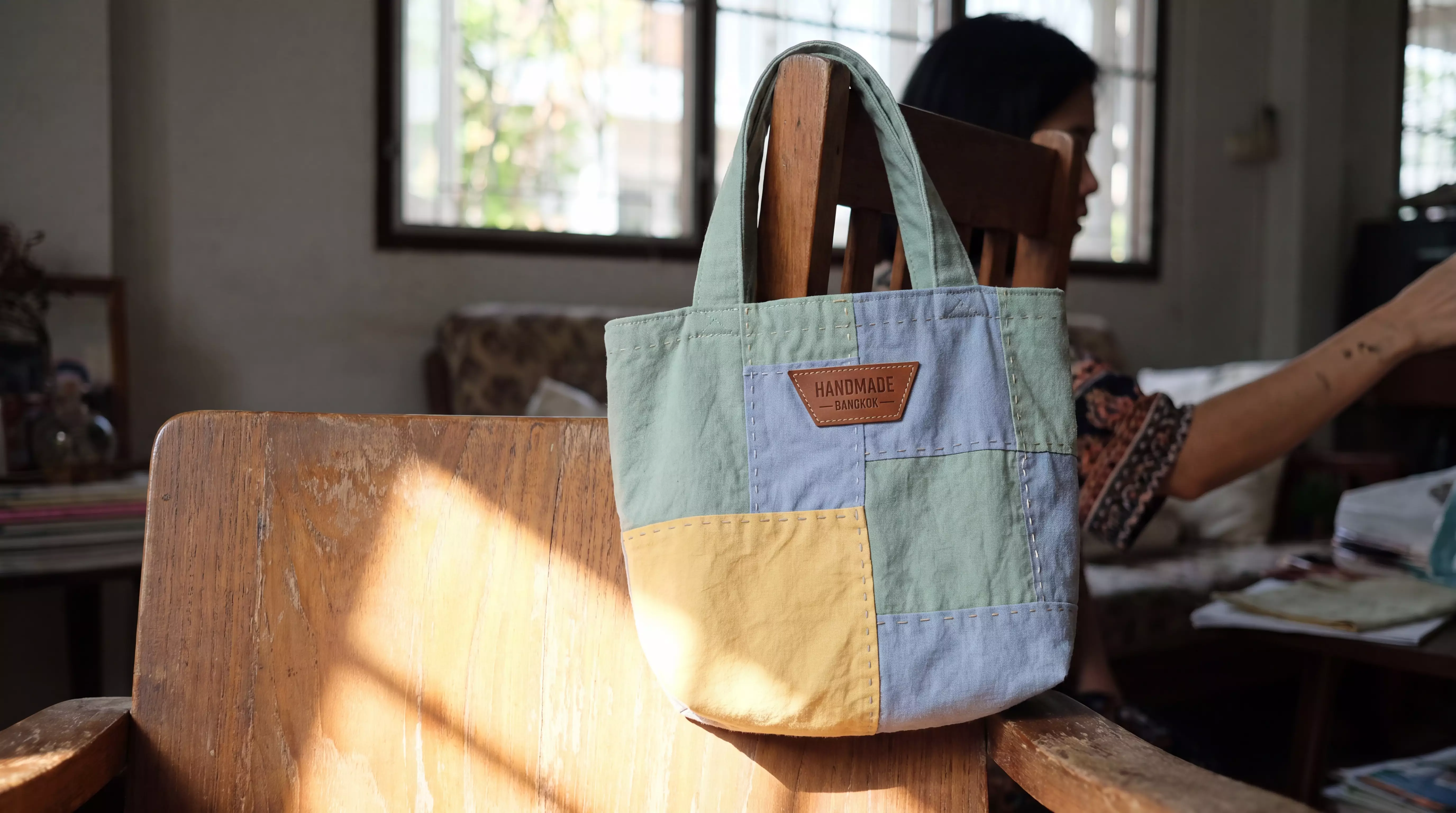Handmade patchwork tote on a chair