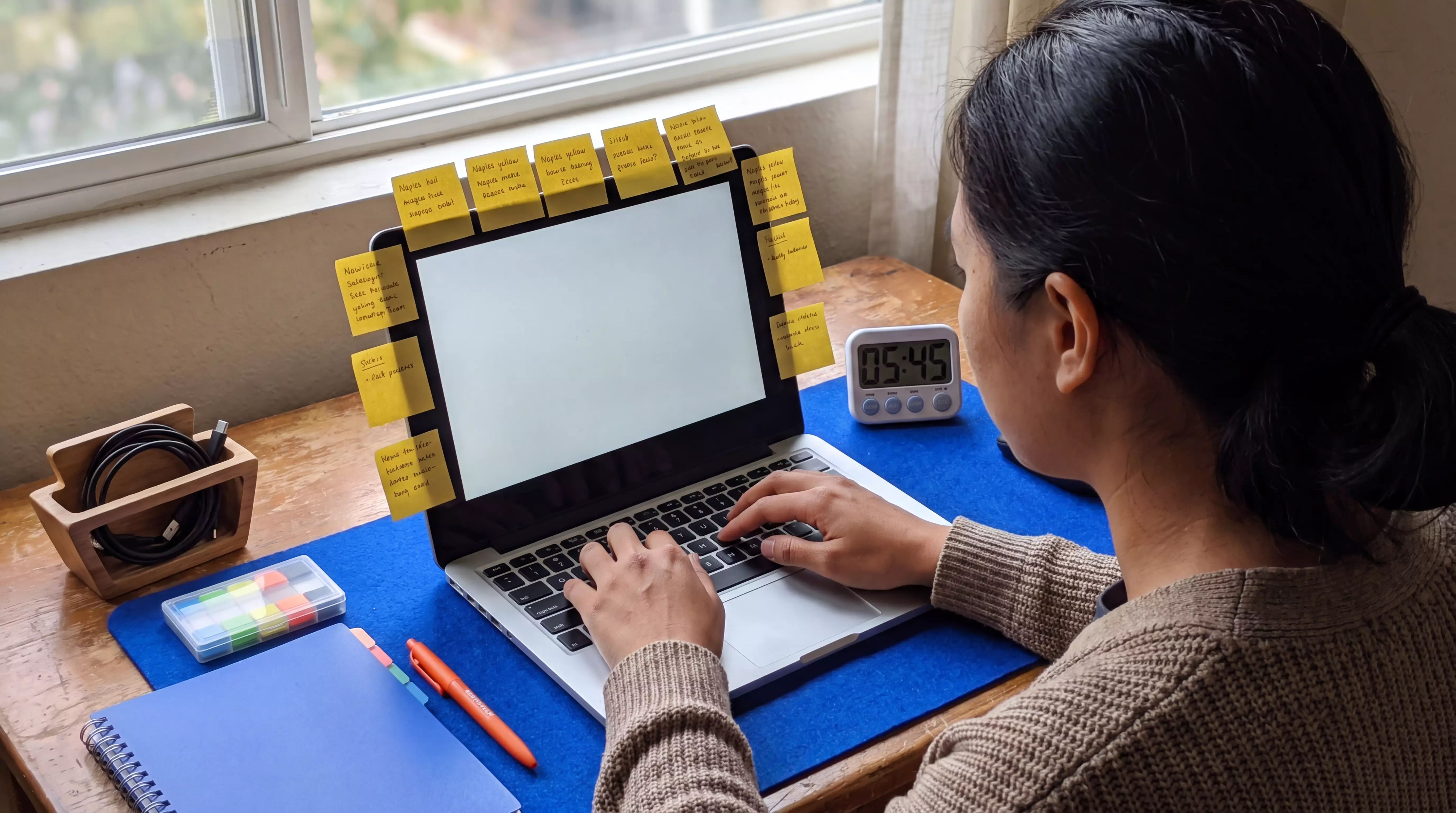 Practitioner typing at a laptop desk